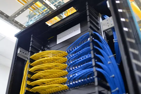 Well-organized server rack with neatly cabled equipment, including a rackmount UPS at the bottom.