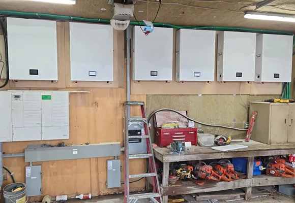 Professional installing a wall mount battery