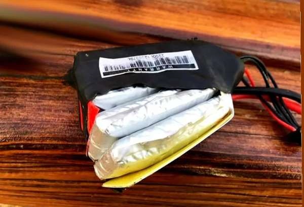 Can batteries be stacked for storage? 5 A dramatic image of a swollen or