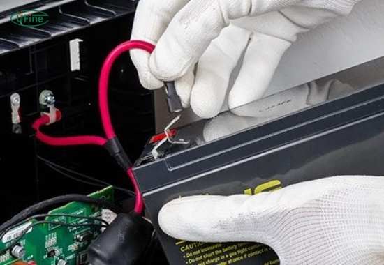 An image of a technician cleaning the dust filter on a rack mount UPS in a clean, cool server room, representing best maintenance practices.